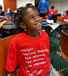 Young TECH CORPS Student Builds Confidence Through Technology Young TECH CORPS student smiles while participating in a hands-on technology learning experience.