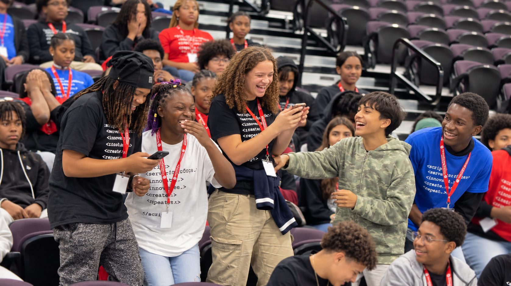 Ohio high school students laugh and celebrate together during the TECH CORPS Hackathon, building teamwork, creativity, and technology skills.