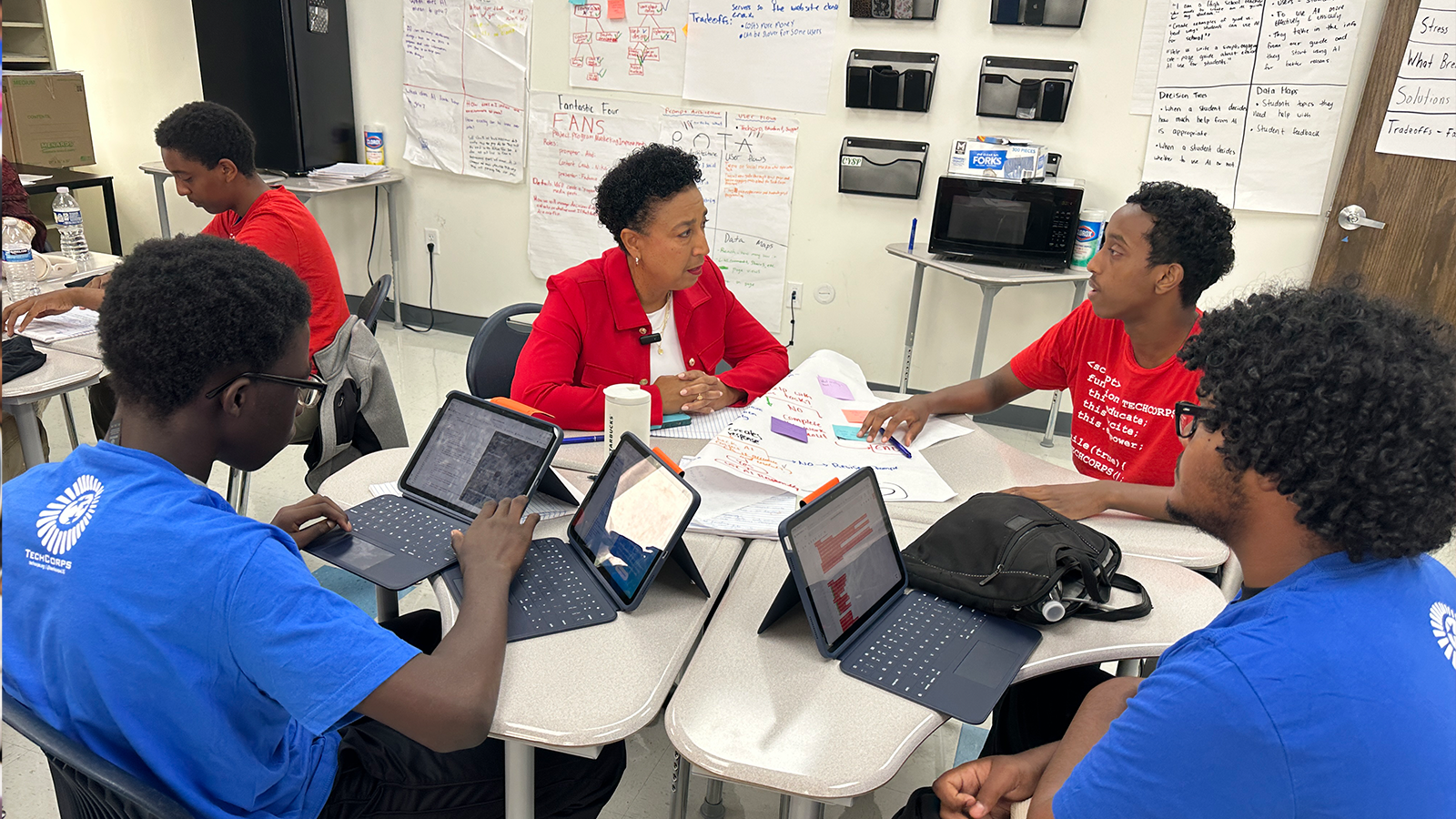 TECH CORPS CEO Lisa M. Chambers Engages with Student TECH CORPS Participants TECH CORPS CEO Lisa M. Chambers listens as Student TECH CORPS participants share their experiences and perspectives during a collaborative technology learning session.